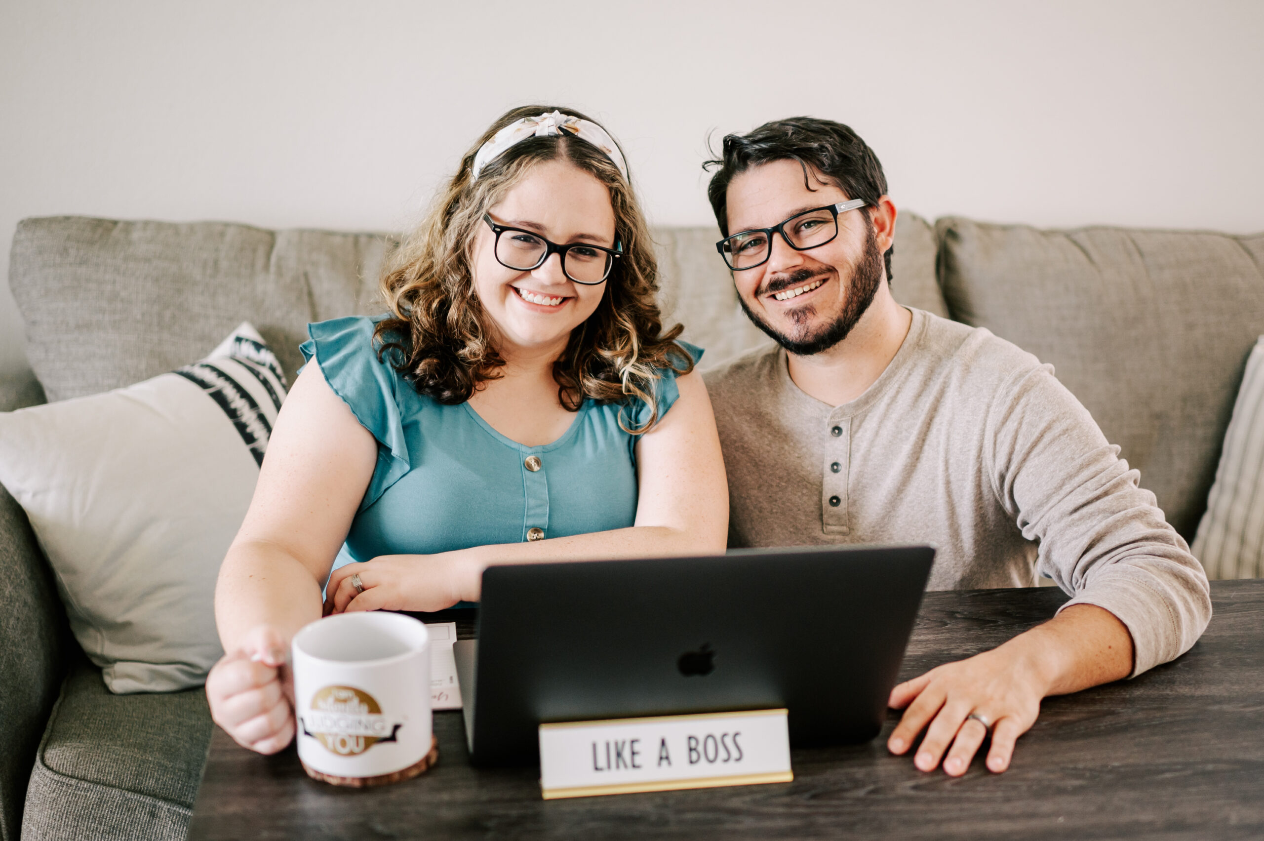 man and woman sitting on a couch with a laptop promoting black friday deals for photographers 