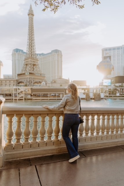 woman standing on a bridge looking out over the las vegas strip