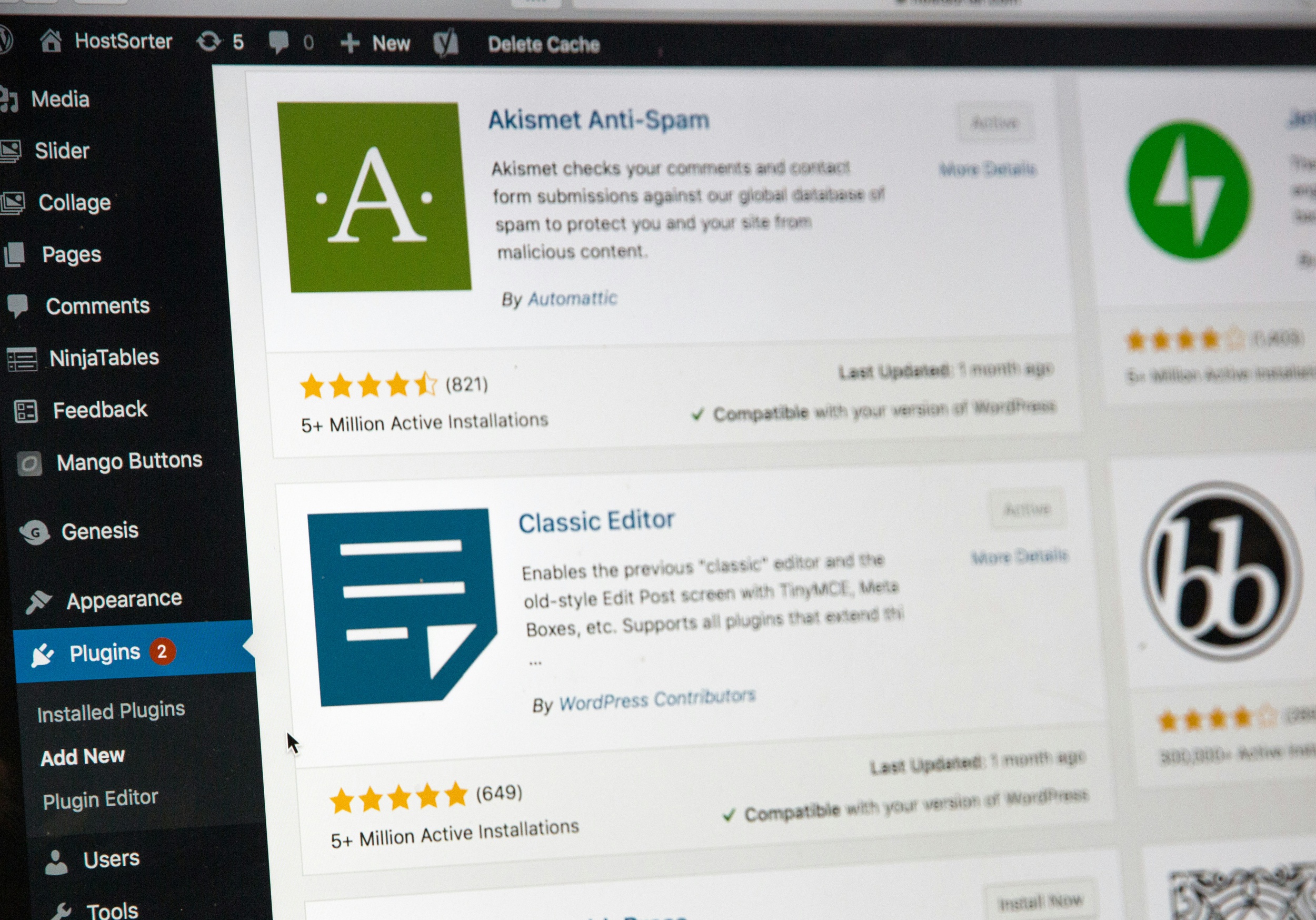 A computer screen showcases the WordPress admin panel, renowned as the best blogging platform for photographers. Visible plugins include Akismet Anti-Spam, highlighted with a green background, and Classic Editor, featuring a blue icon with white lines. This setup ensures seamless content creation and protection.