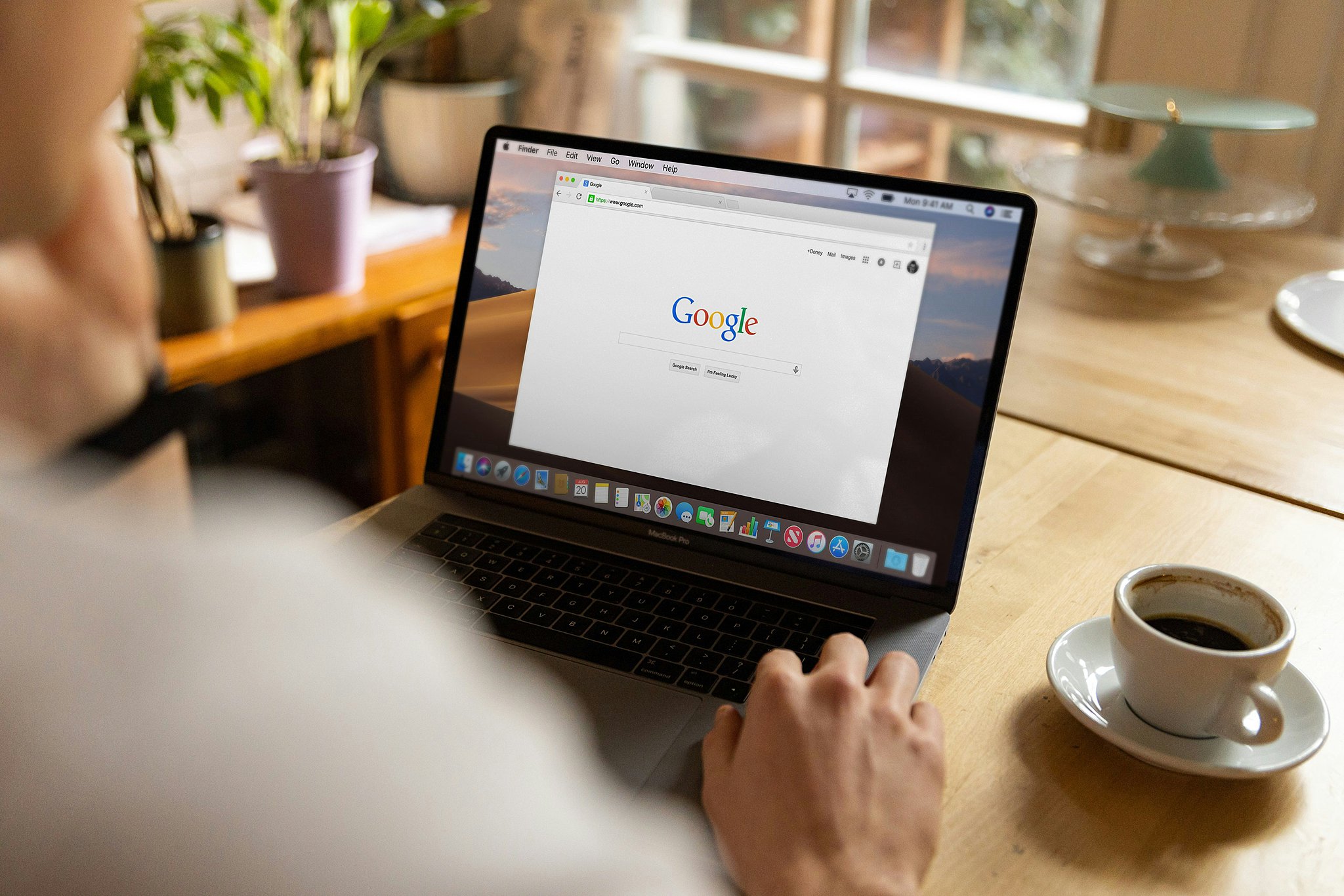 A look over someone's shoulder as they open a web browser at a coffee table